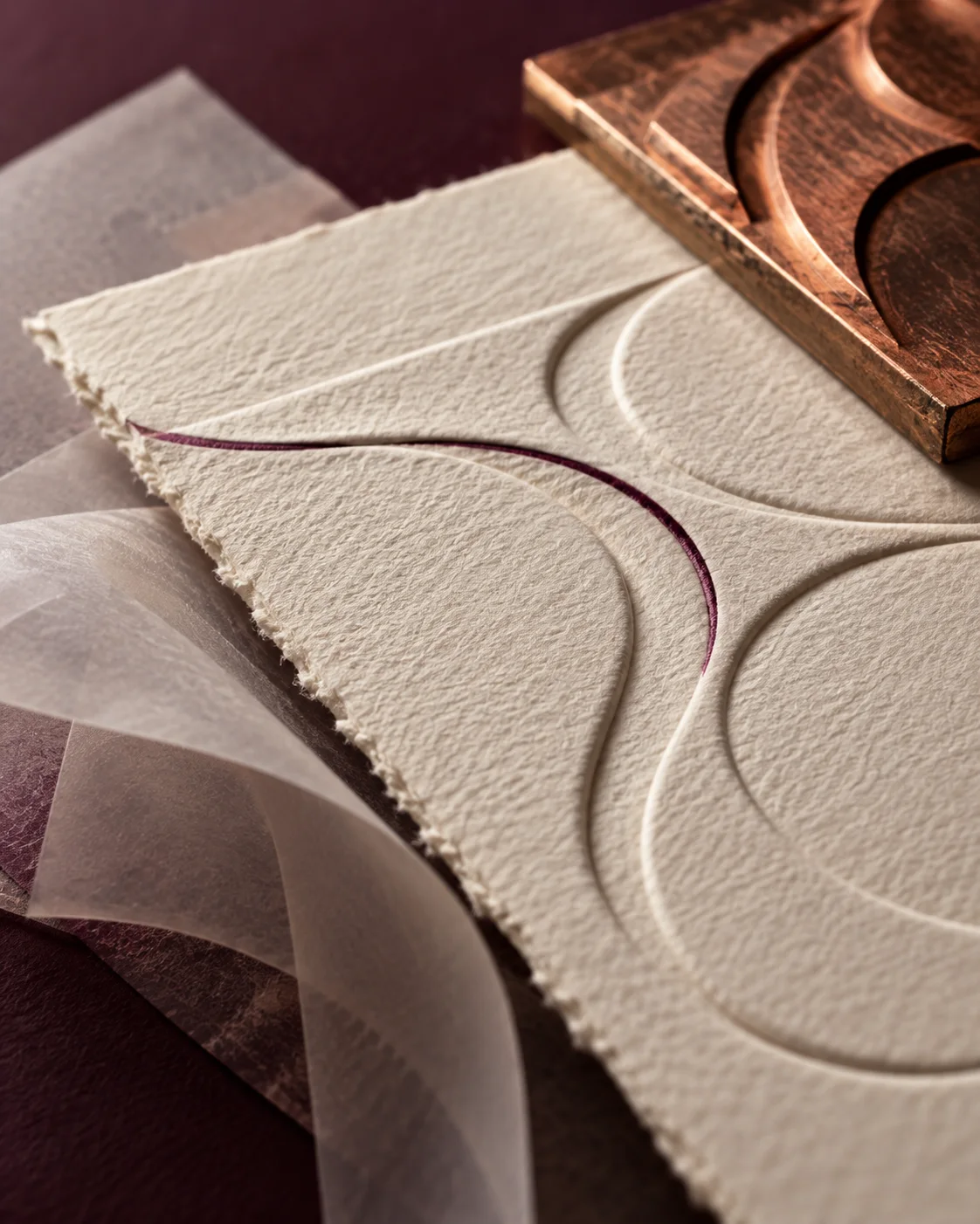 Conceptual close-up of paper relief and a copper printing plate